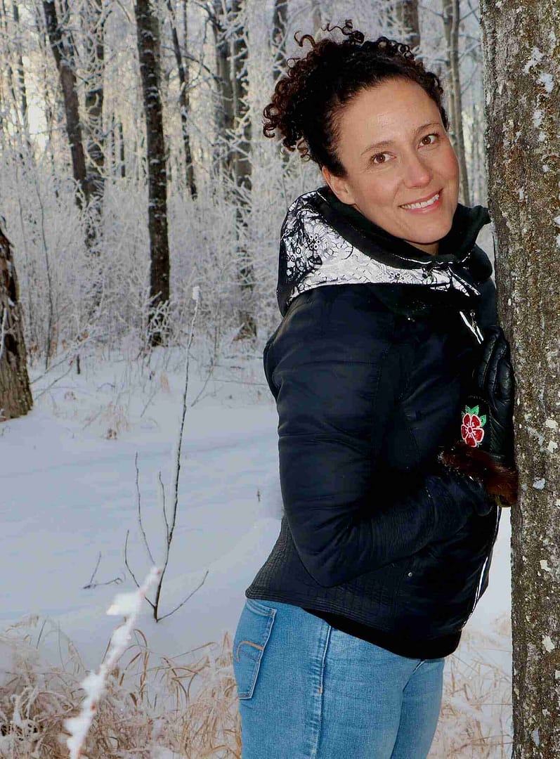Brandy Smart standing against a tree in winter frost